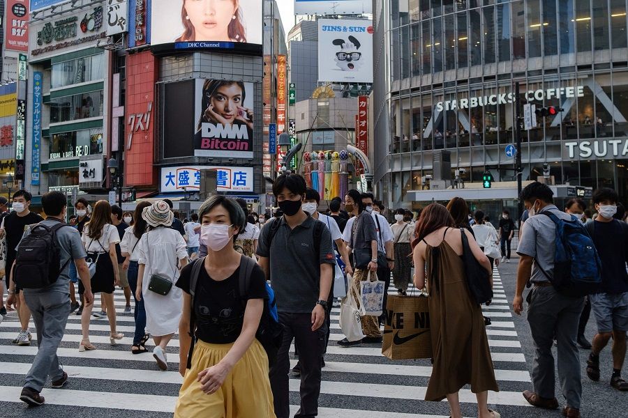 People walk on Shibuya crossing in Shibuya district of Tokyo, Japan on 5 August 2021. (Yuki Iwamura/AFP)