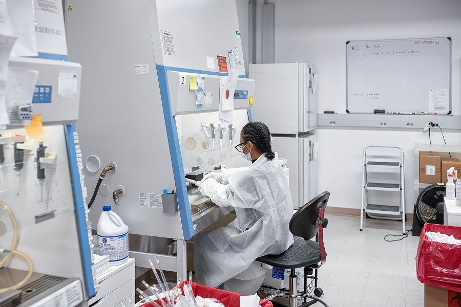 A Mirimus Inc lab scientist works to validate rapid IgM/IgG antibody tests of Covid-19 samples from recovered patients on 10 April 2020 in the Brooklyn borough of New York City. (Misha Friedman/Getty Images/AFP)