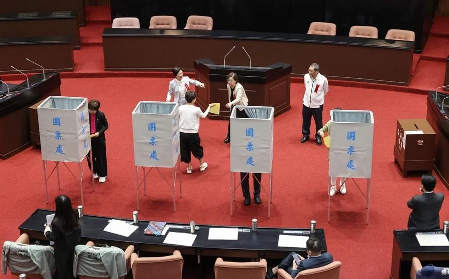 Members of Taiwan's opposition parties vote on an impeachment motion against President Lai Ching-te at Legislative Yuan chamber in Taipei on 19 May 2026.