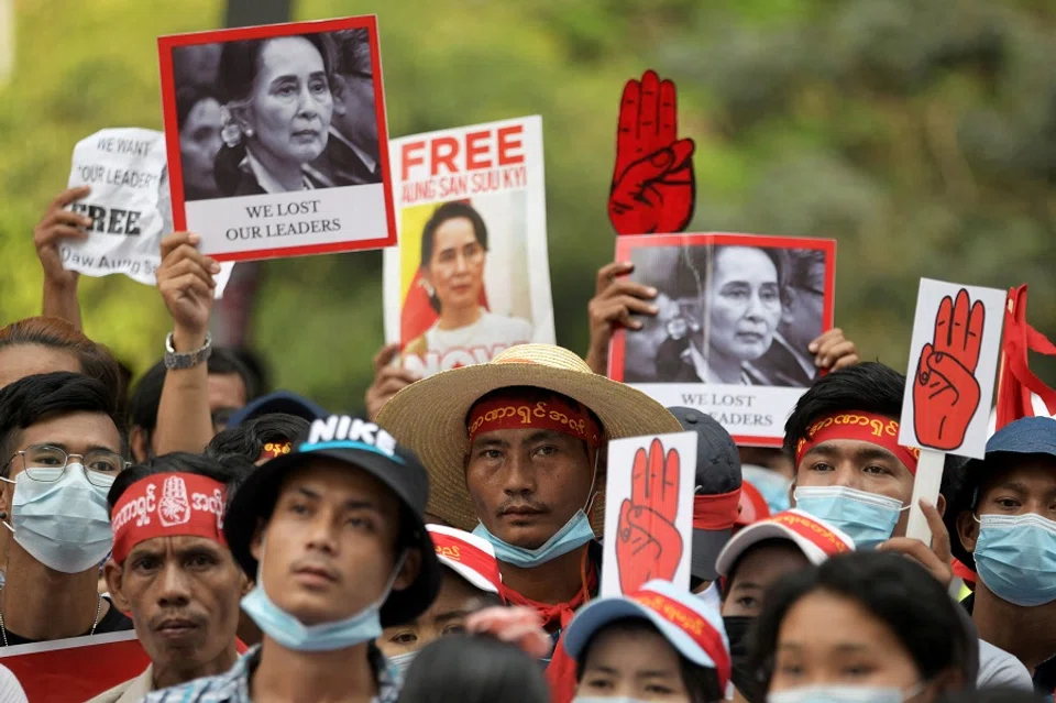 Demonstrators hold placards with pictures of Aung San Suu Kyi as they protest against the military coup in Yangon, Myanmar, 22 February 2021. (Stringer/File Photo/Reuters)