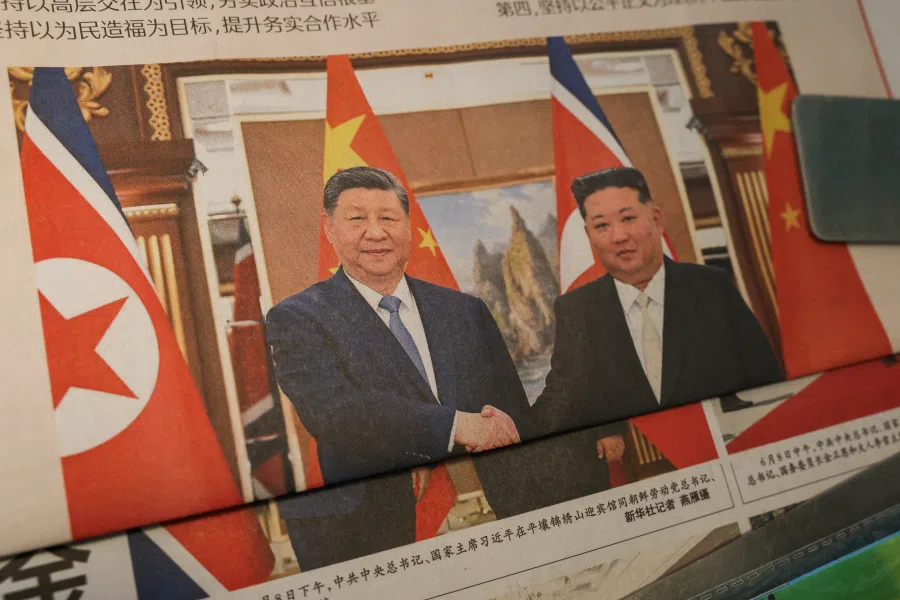 Newspapers with an image of Chinese President Xi Jinping shaking hands with North Korean leader Kim Jong Un during Xi’s state visit to Pyongyang, North Korea, on the front page are displayed, at a news stand in Beijing, China, on 9 June 2026. (Tingshu Wang/Reuters)