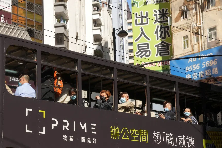 People wearing face masks ride on a bus, following the coronavirus disease (Covid-19) outbreak, in Hong Kong, China, 11 February 2022. (Lam Yik/Reuters)