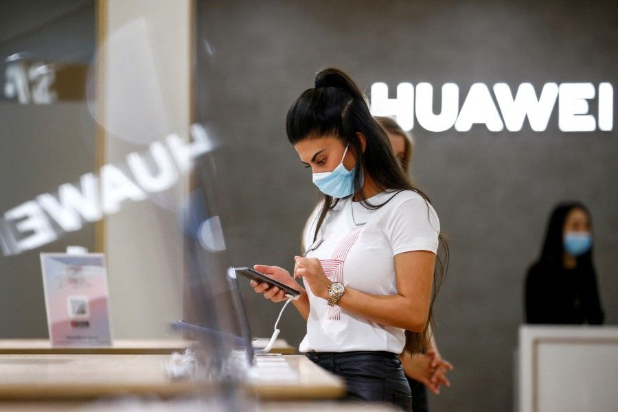 An employee uses a Huawei P40 smartphone at the IFA consumer technology fair, amid the Covid-19 outbreak, in Berlin, Germany, 3 September 2020. (Michele Tantussi/Reuters)