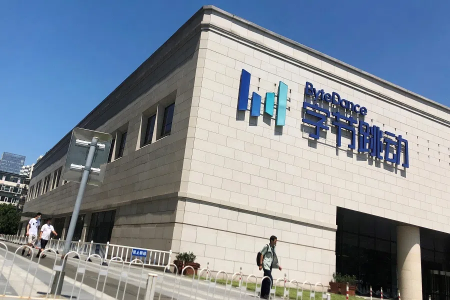 People walk past the Bytedance headquarters building in Beijing, China, 3 August 2020. (Carlos Garcia Rawlins/Reuters)