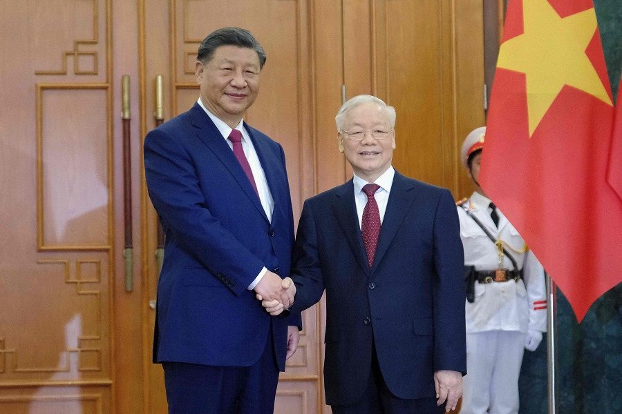 Chinese President Xi Jinping (left) and Vietnamese Communist Party General Secretary Nguyen Phu Trong (right) pose at the Central Office of the Communist Party of Vietnam in Hanoi on 12 December 2023. (Minh Hoang/AFP)