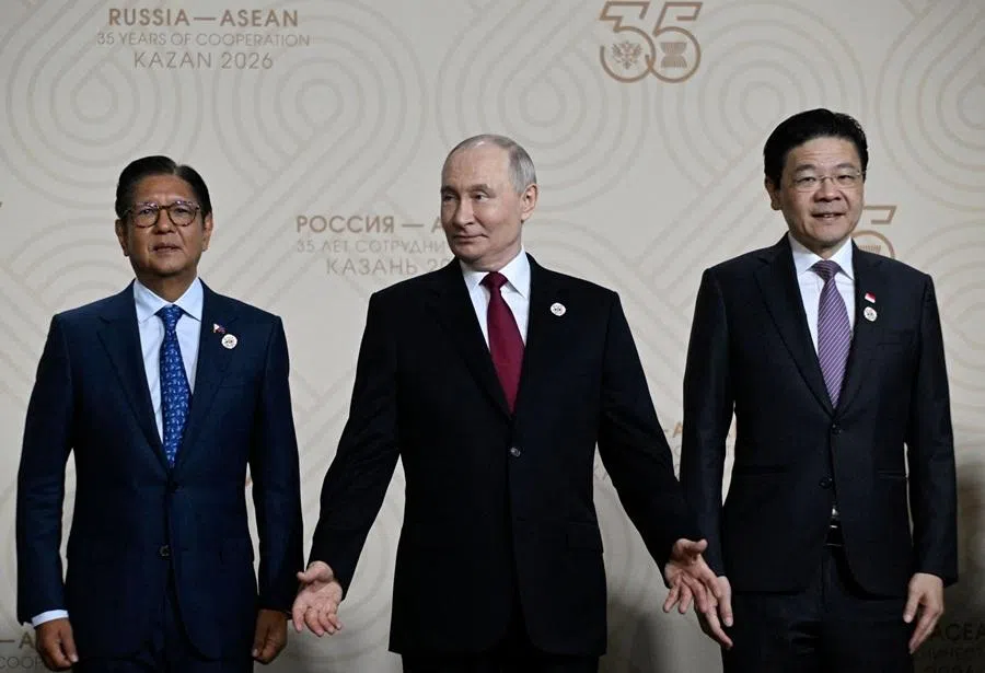 Russian President Vladimir Putin (centre) gestures next to Philippine President Ferdinand Marcos Jr (left) and Singapore's Prime Minister Lawrence Wong during a family photo of the Russia-ASEAN summit, in Kazan, on 18 June 2026.