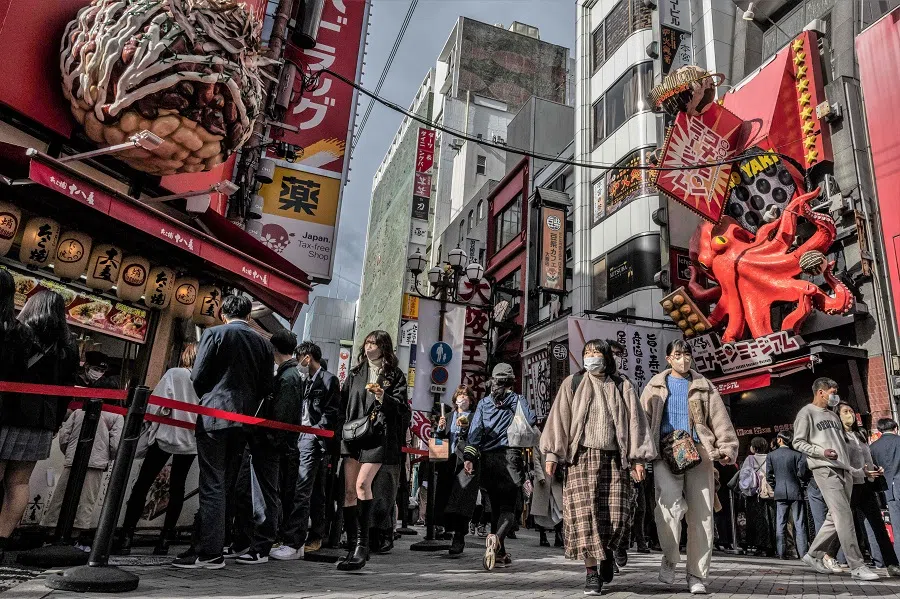 People walk through Dotonbori district in Osaka, Japan, on 1 December 2022. (Yuichi Yamazaki/AFP)