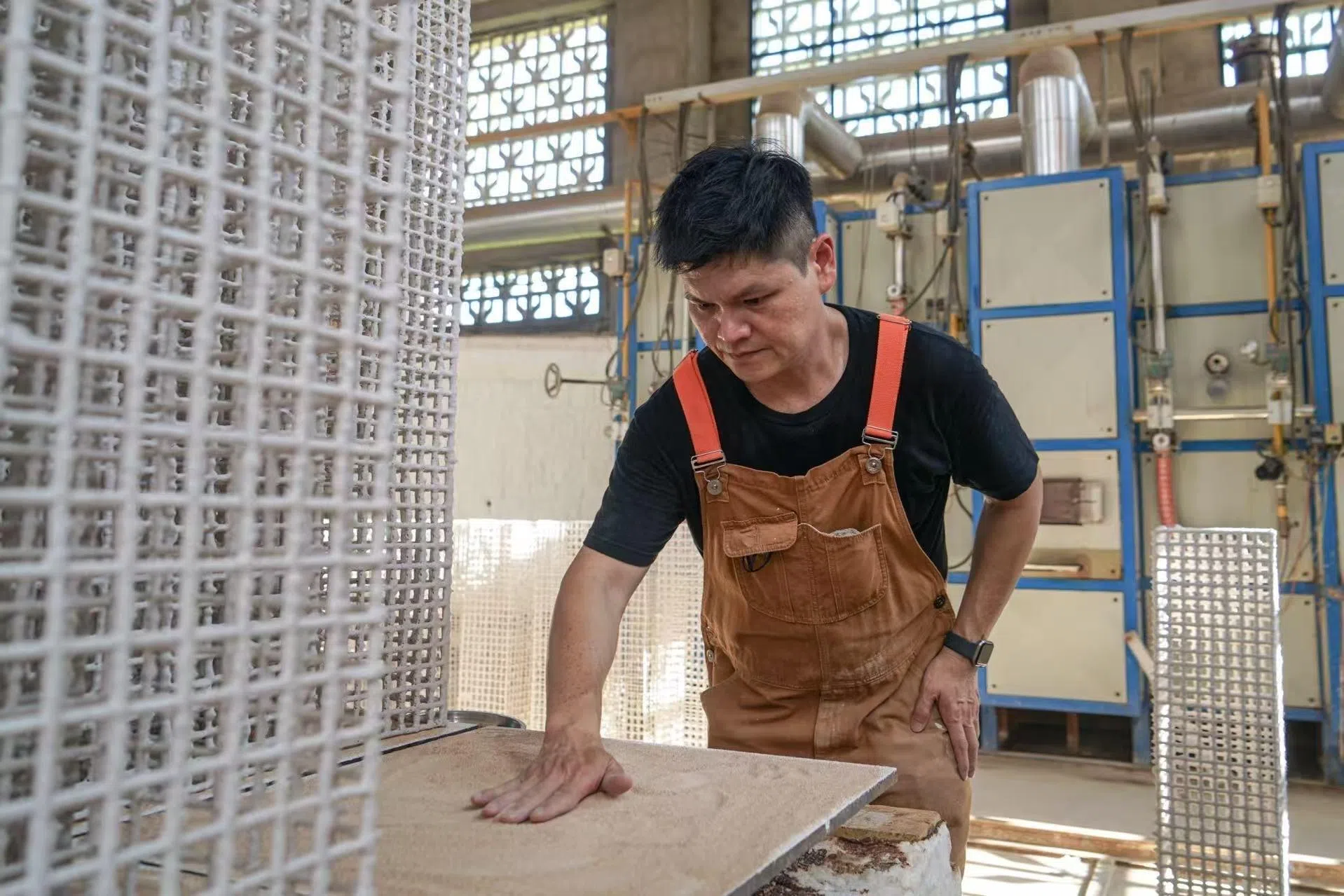 Nelson checking his ceramic installation.