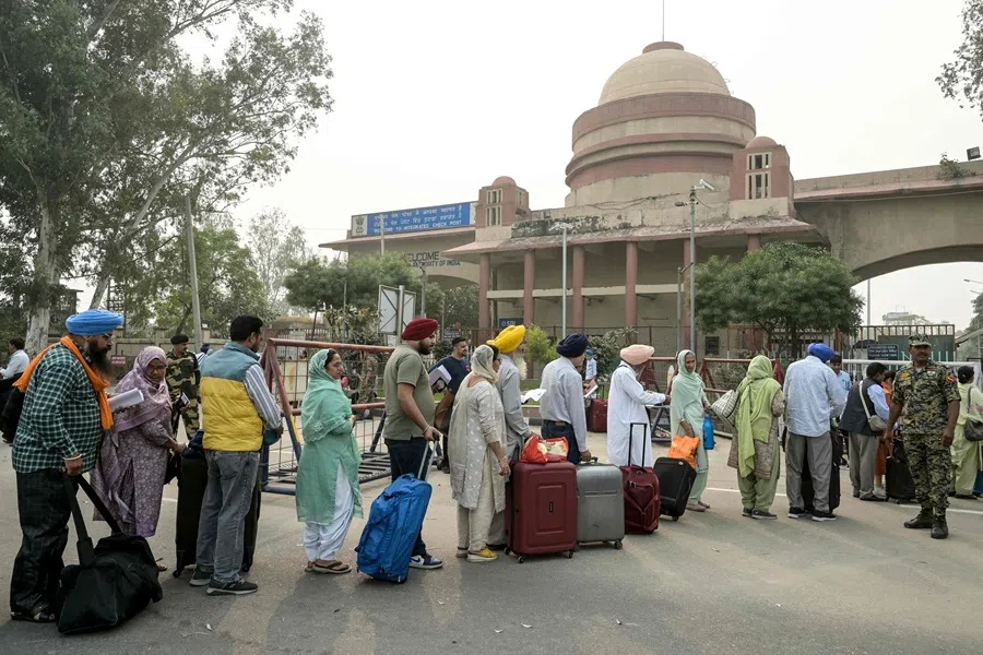 Indian Sikh pilgrims queue at the India-Pakistan Wagah border in Wagah on 4 November 2025, for their visit to Pakistan to pay their respects on the eve of celebrations marking the birth anniversary of Guru Nanak, founder of Sikhism. (Narinder Nanu/AFP)