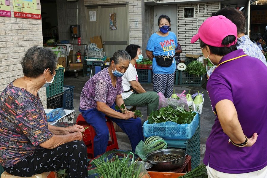 Women chat at a market on Nangan island of Matsu archipelago in Taiwan, 17 August 2022. (Ann Wang/Reuters)