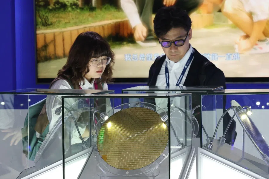 People look at semiconductor products made by Hua Hong Group at the SEMICON China semiconductor exhibition in Shanghai, China, on 26 March 2025.