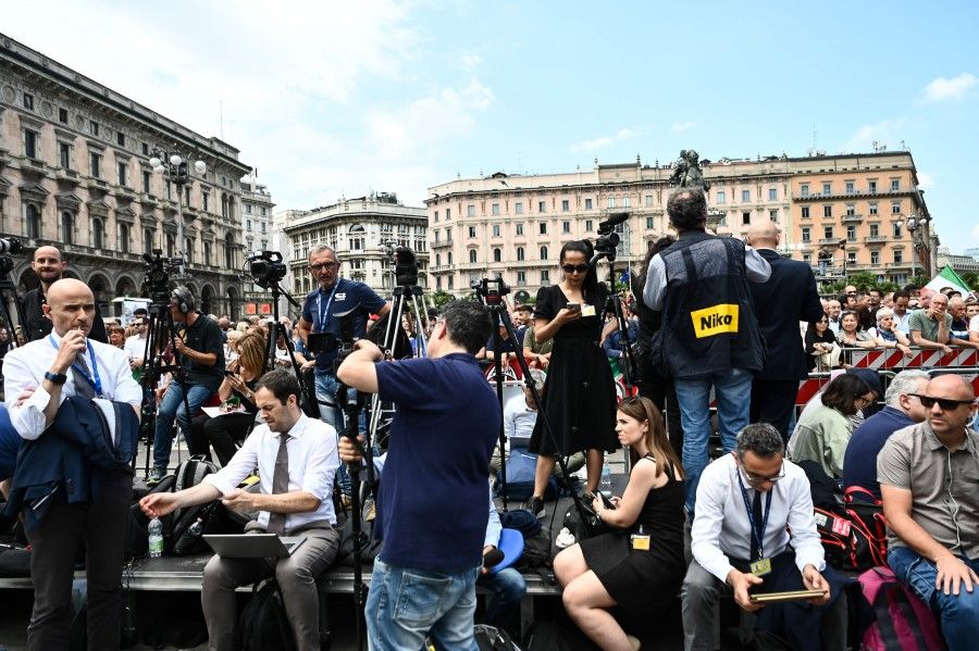 Reporters, journalists and cameramen wait outside the Duomo cathedral in Milan on 14 June 2023 ahead of the state funeral for Italy's former prime minister and media mogul Silvio Berlusconi. (Piero Cruciatti/AFP)