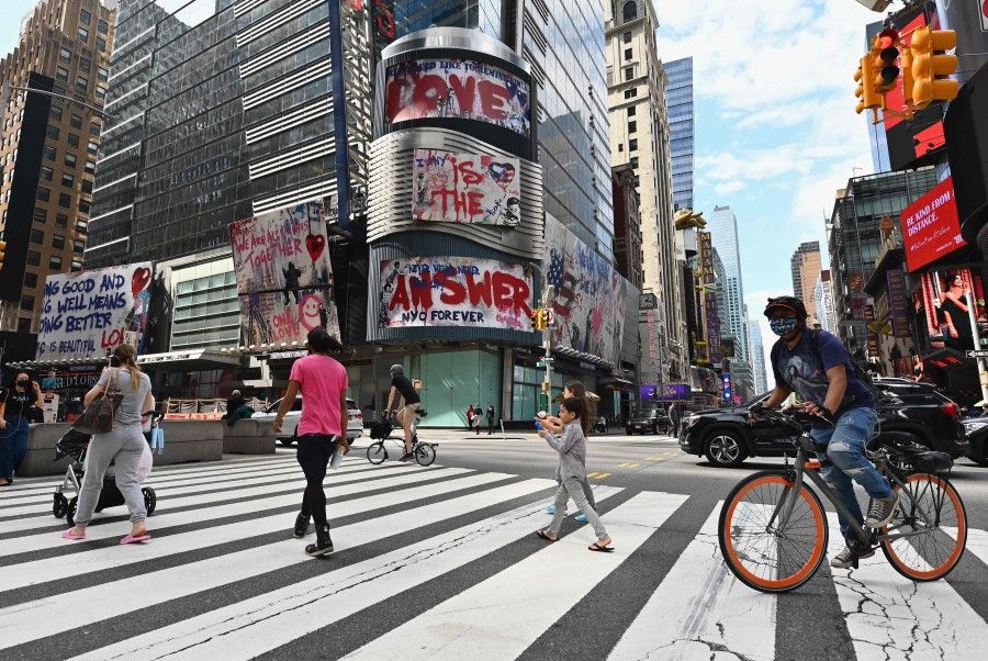People cross the street near Time Square on 28 September 2020 in New York City. (Angela Weiss/AFP)