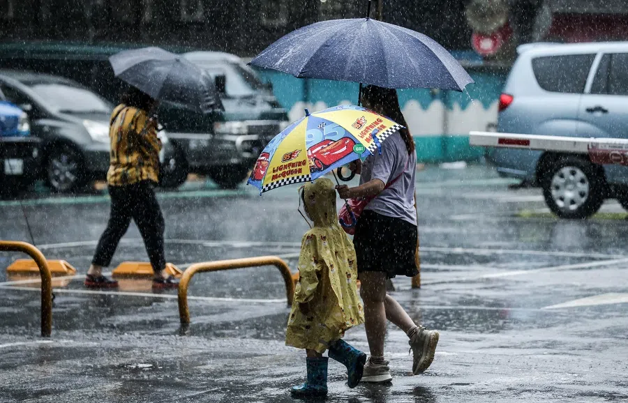 People walk on a street in Keelung, Taiwan on 4 September 2023. (I-Hwa Cheng/AFP)