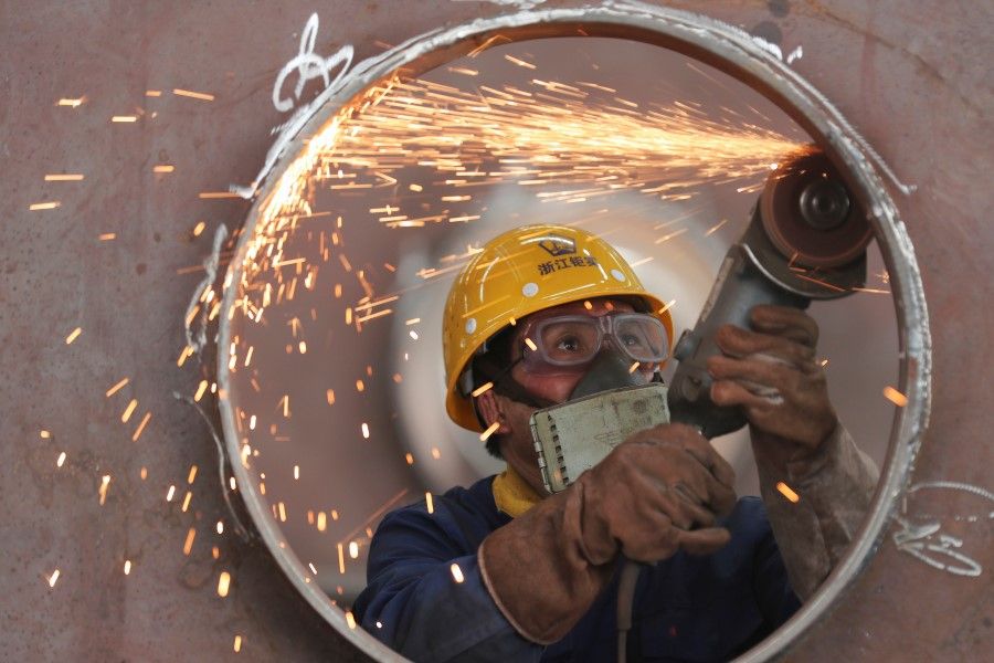 An employee works on a production line manufacturing steel structures at a factory in Huzhou, Zhejiang province, China, on 17 May 2020. (China Daily via Reuters)