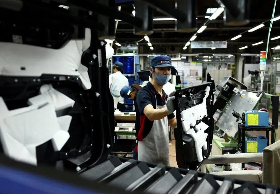Employees work on the assembly line at Nanjo Auto Interior, a manufacturer of inside door panels and other parts for Mazda Motor, in Akitakata, Hiroshima prefecture, Japan, on 14 July 2025.
