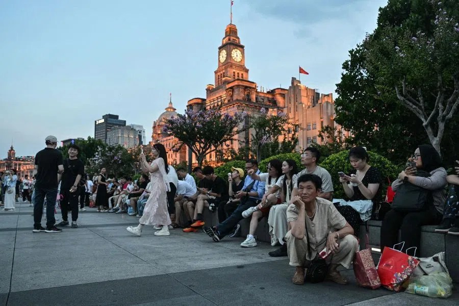 People visit the Bund promenade along the Huangpu river in Shanghai on 17 July 2026.