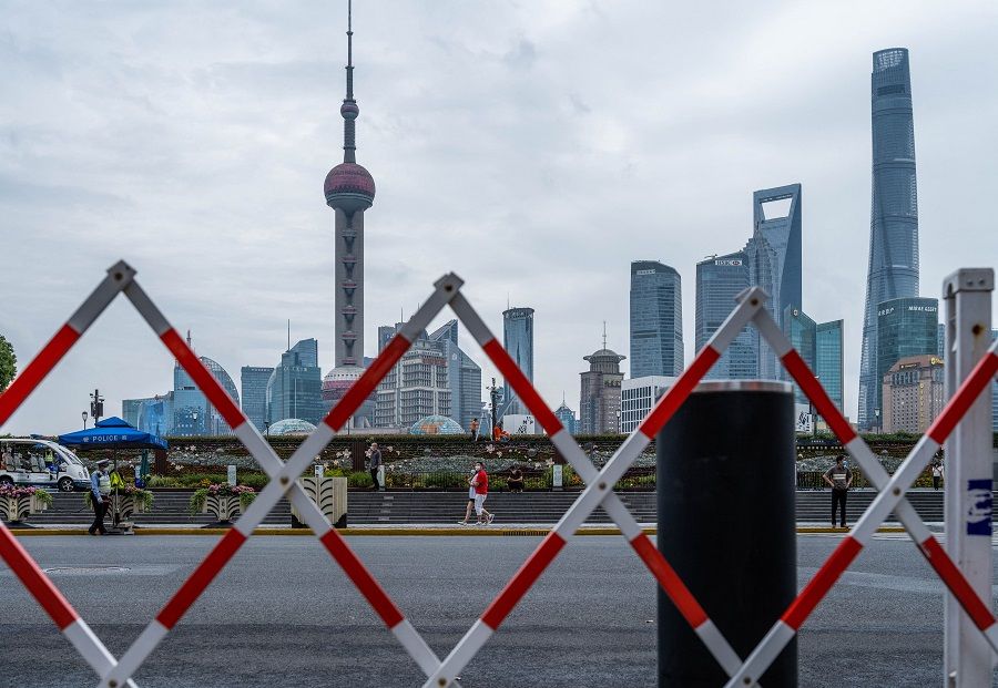 Pedestrians walk on the Bund in Shanghai, China, on 10 June 2022. (Liu Jin/AFP)