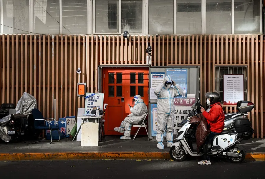 Security personnel guard an entrance to a residential area under lockdown due to Covid-19 restrictions in Beijing, China, on 26 November 2022. (Noel Celis/AFP)