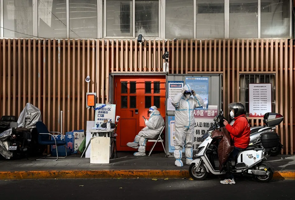 Security personnel guard an entrance to a residential area under lockdown due to Covid-19 restrictions in Beijing, China, on 26 November 2022. (Noel Celis/AFP)