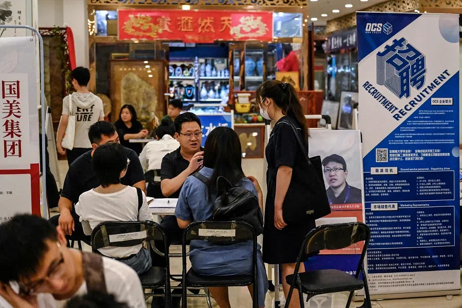 This photo taken on 19 August 2023 shows people attending a job fair in Beijing, China. (Jade Gao/AFP)