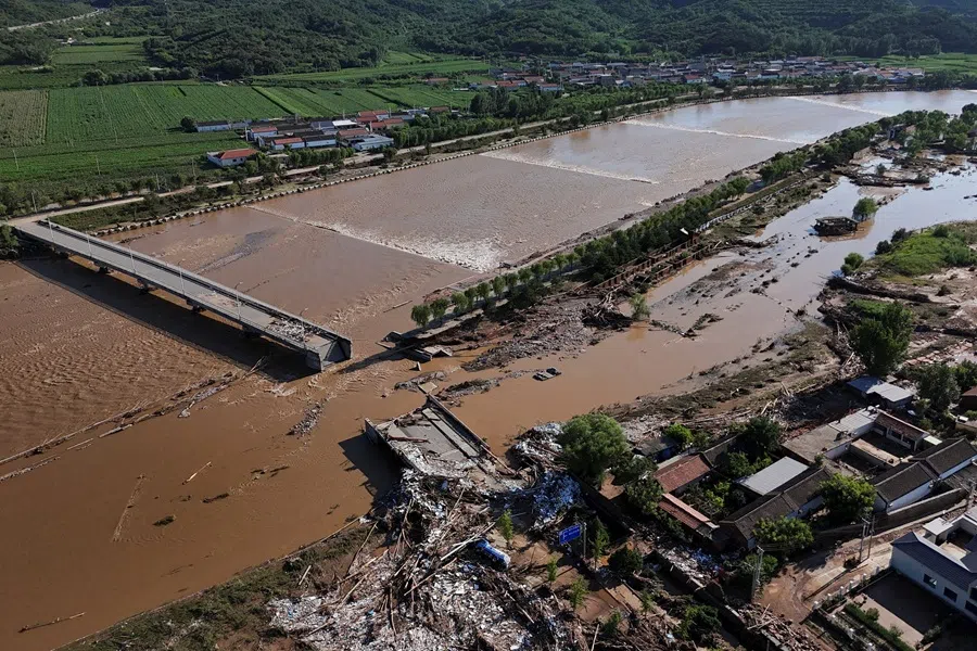 A drone view shows damaged roads and fallen trees next to the overflowing Qingshui river after heavy rainfall flooded the area, in Miyun district of Beijing, China, on 29 July 2025. (Florence Lo/Reuters)
