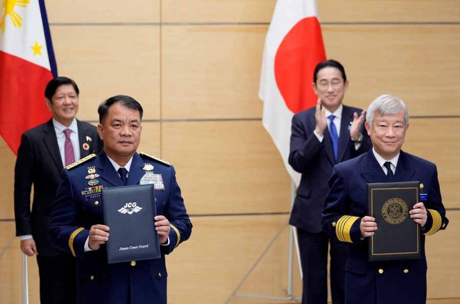 Japan's Prime Minister Fumio Kishida (back right) and Philippines President Ferdinand Marcos Jr. (back left) attend a document exchange ceremony with Japan Coast Guard Commandant Shohei Ishii (front right) and Philippine Coast Guard Commandant Ronnie Gil Gavan (front left) at the prime minister's official residence in Tokyo, Japan, 17 December 2023. Both countries leaders met on the sidelines of the Commemorative Summit for the 50th Year of ASEAN-Japan Friendship and Cooperation. (Franck Robichon/Reuters)