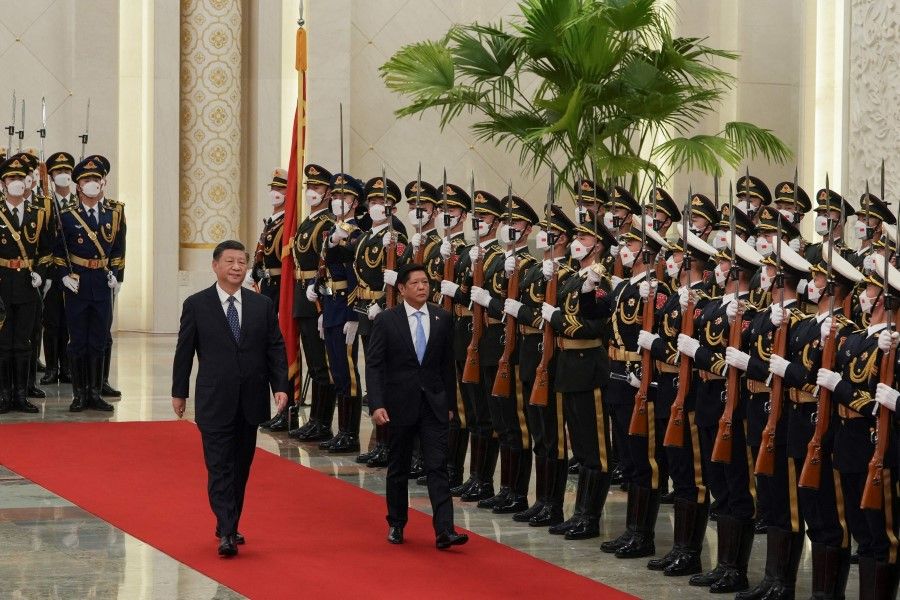 In this file handout photo released by the Philippines' Office of the Press Secretary and taken on 4 January 2023, China's President Xi Jinping (left) and Philippine President Ferdinand Marcos Jr review an honour guard during a welcome ceremony at the Great Hall of People in Beijing. (Handout/Philippines's Office of the Press Secretary/AFP)