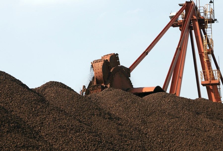 A conveyer belt dumps iron ore into a pile at an iron ore transfer and storage centre operated by the Shanghai International Port Group in Shanghai, China, on 26 January 2010. (Qilai Shen/Bloomberg)
