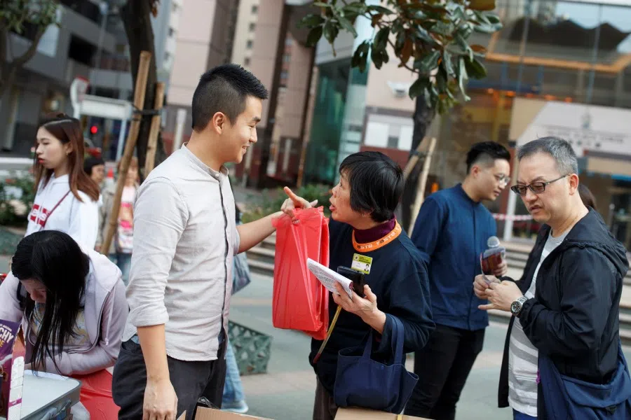 Incoming district councillors Tat Cheng (3rd L) and Lee Yue-Shun (2nd R) at a public engagement exercise in North Point, Hong Kong, December 2019. Young people have been highly involved in Hong Kong politics recently, and are likely to continue making a difference in future. (Thomas Peter/REUTERS)