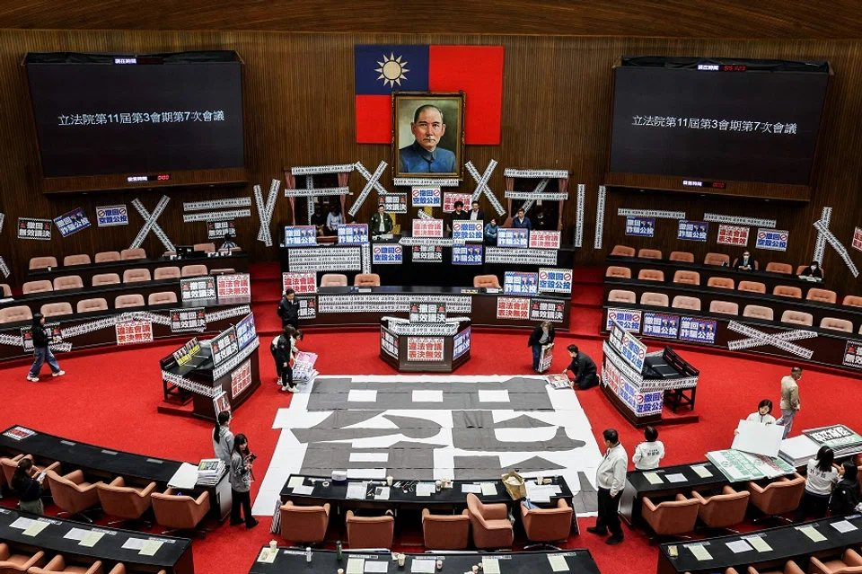 A poster reading “recall” is placed on the floor and banners reading “Illegal meeting, invalid resolution” are plastered throughout the Legislative Yuan in Taipei, Taiwan on 28 March 2025. (I-Hwa Cheng/AFP)