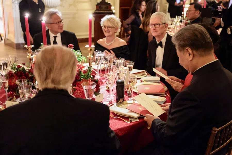 US President Donald Trump and Chinese President Xi Jinping sit together during a state dinner at the White House in Washington, DC, US, on 24 September 2026. With them are NVIDIA CEO Jensen Huang (first from left) and Apple executive chairman Tim Cook (third from left).