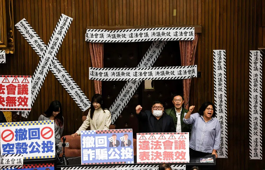 Lawmakers of Taiwan’s ruling party (DPP) shout “illegal meeting, invalid resolution” against the two referendum proposals that have been passed by Kuomintang (KMT) at the Legislative Yuan in Taipei, Taiwan on 28 March 2025. (I-Hwa Cheng/AFP)