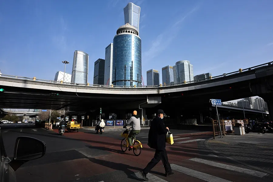 A man crosses the road in the central business district of Beijing, China. (SPH Media)