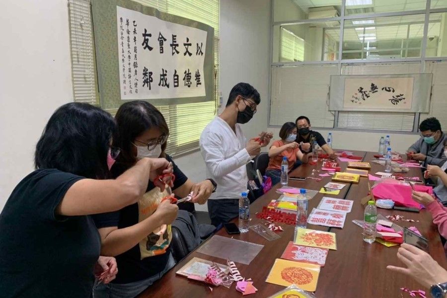 Students and staff at Huachiew Chalermprakiet University (HCU) making Chinese New Year decorations, 10 February 2022. (HCU/Facebook)