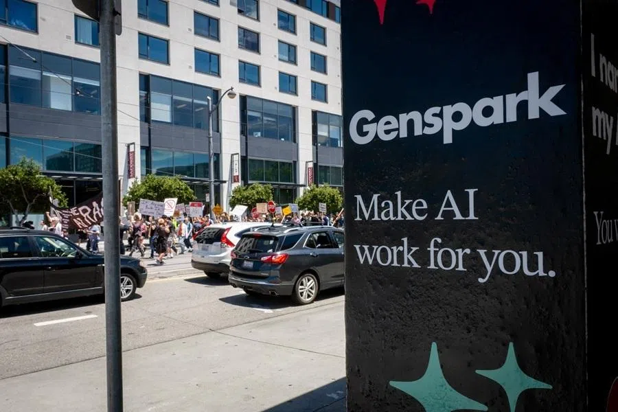 Demonstrators walk by an AI advertisement at a Caltrain Station as they participate in the "Stop the AI Race" protest march in San Francisco, California, on 11 July 2026.