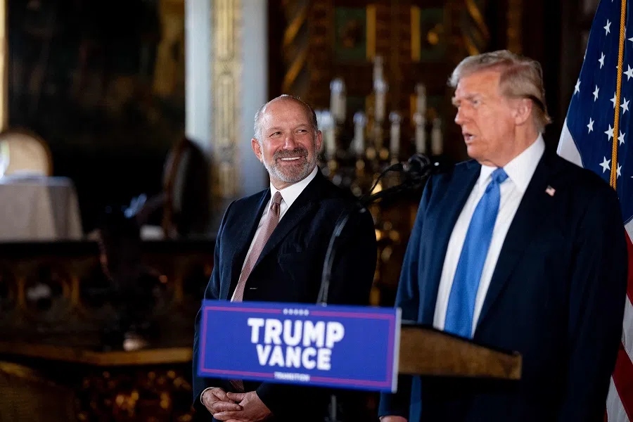 US President-elect Donald Trump, accompanied by Trump’s choice for secretary of commerce, Cantor Fitzgerald chairman and CEO Howard Lutnick, speaks at a news conference at Trump’s Mar-a-Lago resort on 16 December 2024 in Palm Beach, Florida. (Andrew Harnik/Getty Images via AFP)