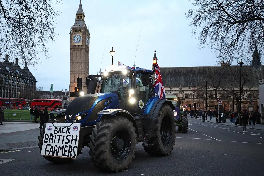Farmers drive tractors around Parliament Square during a demonstration organised by Save British Farming against UK food policy, substandard imports and stricter food labelling regulations, in central London on 25 March 2024, as they call for the government to act to save British farming. (Henry Nicholls/AFP)