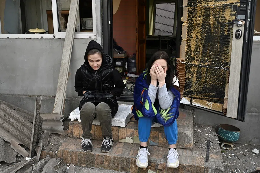 Women react next to their house damaged by a Russian air strike, amid Russia’s attack on Ukraine, in Zaporizhzhia, Ukraine, on 12 October 2024.