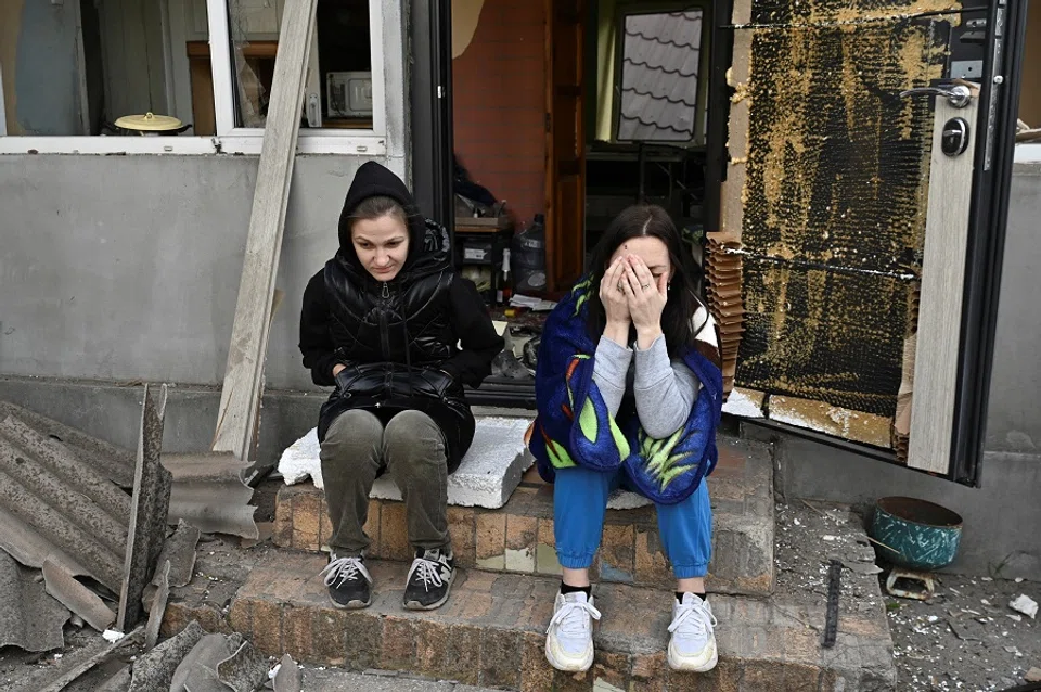 Women react next to their house damaged by a Russian air strike, amid Russia’s attack on Ukraine, in Zaporizhzhia, Ukraine, on 12 October 2024. (Stringer/Reuters)