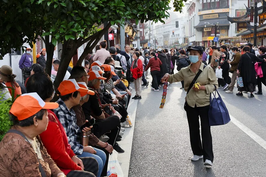 A street merchant tries to sell toys to visitors outside Yuyuan Garden in Shanghai, China, on 16 April 2025. (Go Nakamura/Reuters)