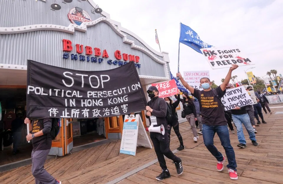 Local natives of Hong Kong participate in a flash mob march to show solidarity with the 47 pro-democracy activists in Hong Kong who were charged for state subversion due to them organizing and taking part in a primary election, in Santa Monica, California on 7 March 2021. (Ringo Chiu/AFP)