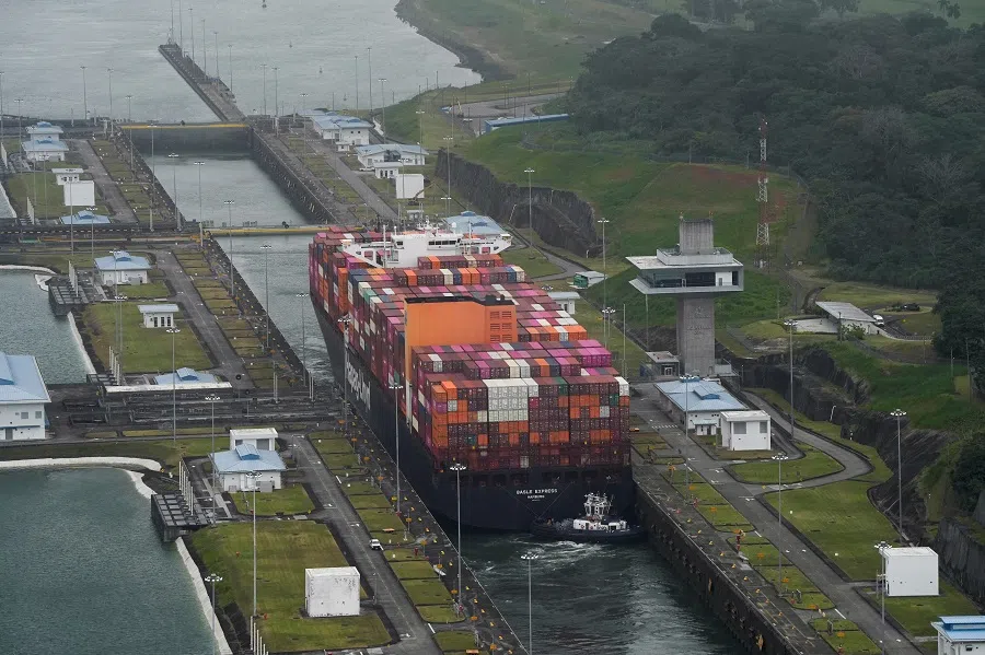 An aerial view shows a cargo vessel transiting through the Cocoli Locks at the Panama Canal, in Panama City, Panama, on 1 February 2025. (Enea Lebrun/Reuters)