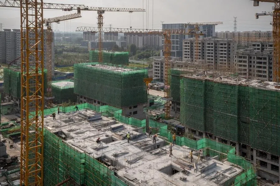 Workers labour at the China Evergrande Group. Royal Peak residential development under construction in Beijing, China, on 29 July 2022.