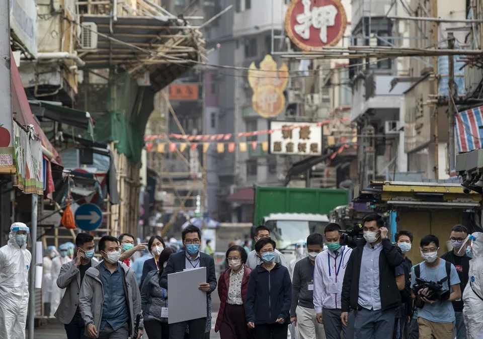 Carrie Lam, Hong Kong's chief executive, centre, walks in an area under lockdown in the Jordan area of Hong Kong, China, on 23 January 2021. (Paul Yeung/Bloomberg)