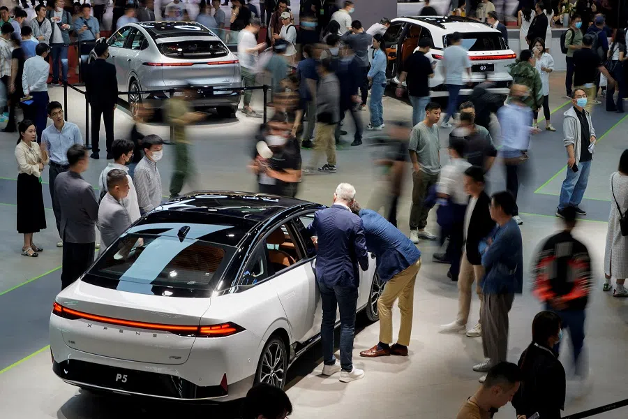 People visit the XPeng Motors booth at the Shanghai Auto show, in Shanghai, China, on 19 April 2023. (Aly Song/Reuters)