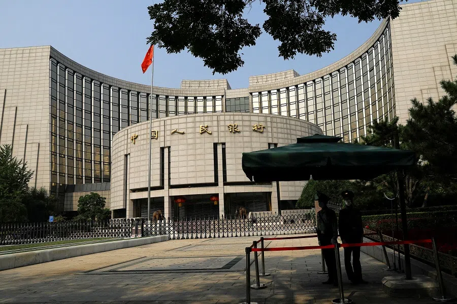 Paramilitary police officers stand guard in front of the headquarters of the People's Bank of China in Beijing, China, on 30 September 2022. (Tingshu Wang/Reuters)