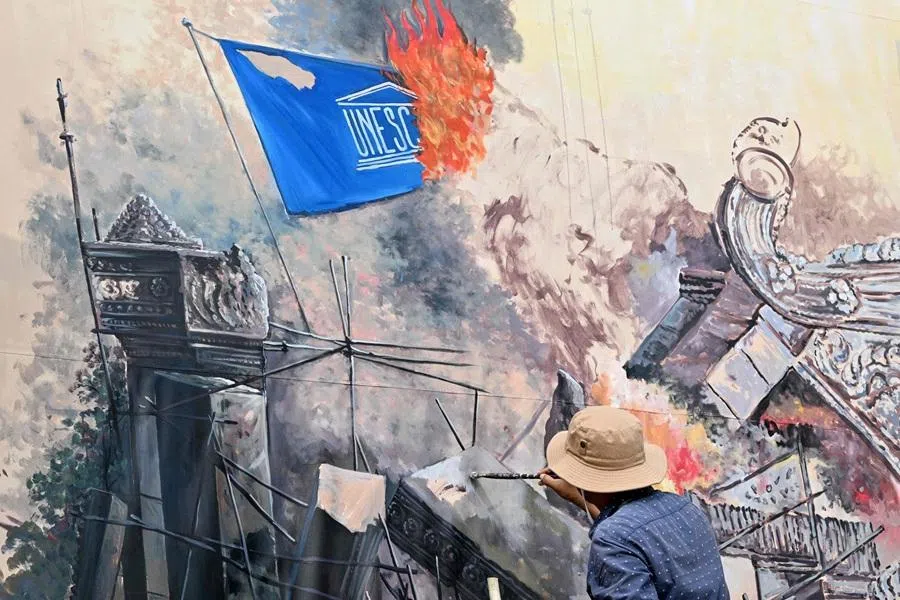 An artist works on a mural under the theme “Art for Peace” depicting the conflict between Cambodia and Thailand at a park in Phnom Penh, Cambodia, on 24 February 2026. (Tang Chhin Sothy/AFP)