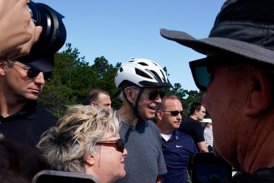 US President Joe Biden talks with members of the public during a bike ride in Rehoboth Beach, Delaware, US, 18 June 2022. (Elizabeth Frantz/Reuters)