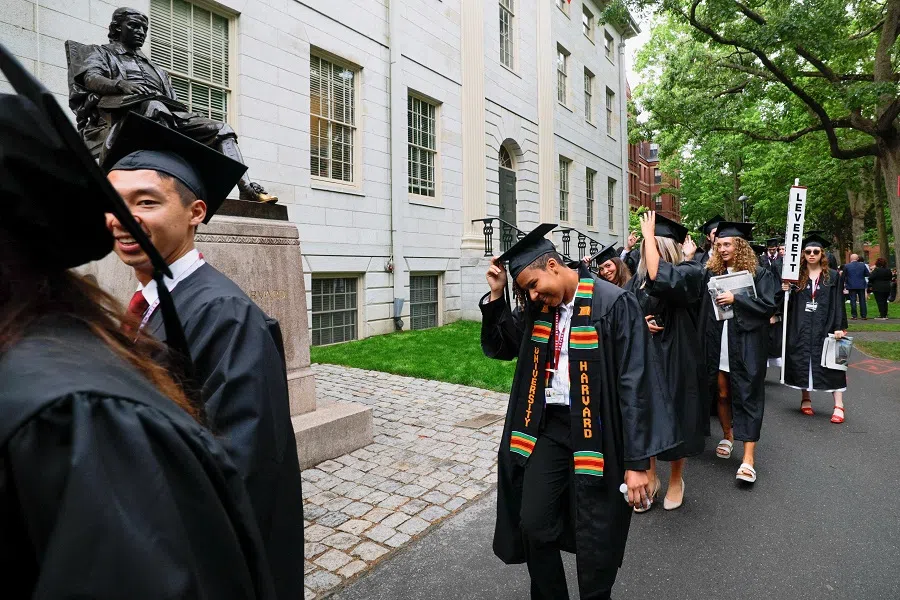 Students walk near the statue of John Harvard on the day of the 374th Commencement exercises at Harvard University in Cambridge, Massachusetts, US, on 29 May 2025. (Brian Snyder/Reuters)